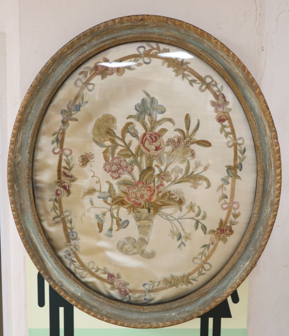 An early 19th century silkwork panel of flowers in a cornucopia, oval 50 x 42cm